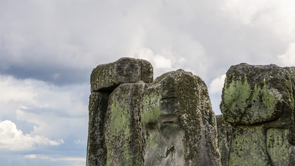 Iconic Stonehenge historial site against clouds and vibrant grass