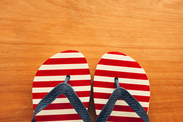 Beach sandals flip flops on wooden background