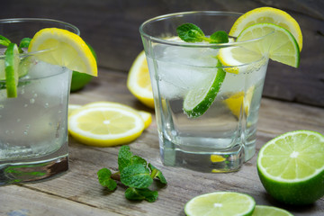 Summer cocktail. Mojito, tonic water with mint, lemon, lime, and ice cubes