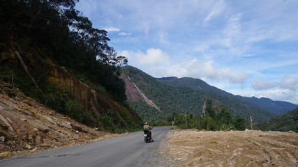 Fototapeta na wymiar Traveling by motorbike through the highlands of Central Vietnam