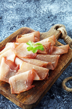 Italian prosciutto crudo or jamon with parsley. Raw ham