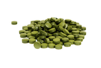 Spirulina algae pills on white background