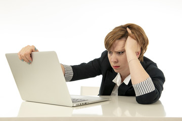 Attractive young business woman working on her computer stressed, unhappy and overwhelmed.