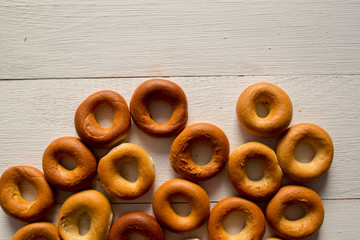 Baked bread bagels on a white surface, background.
