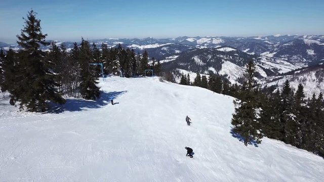 Aerial. Mountain skiers silhouettes. Winter ski rest time.

