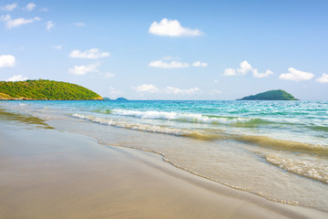clouds on blue sky over calm sea with sunlight reflection