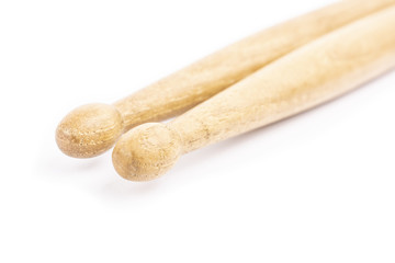 Two wooden drumsticks lying, isolated on a white background