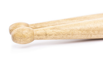 Two wooden drumsticks lying, isolated on a white background