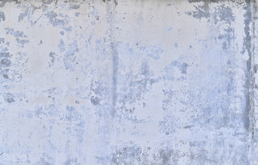 Part of the concrete wall with loose plaster of the old building. Background