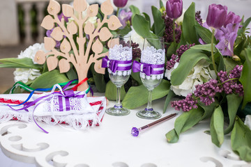 wedding table for a newly-married couple. beautifully decorated glasses in purple style,