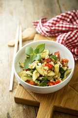 Asian style cucumber appetizer with tomatoes and fresh basil
