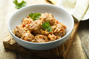 Homemade meatballs with rice, tomato and fresh parsley