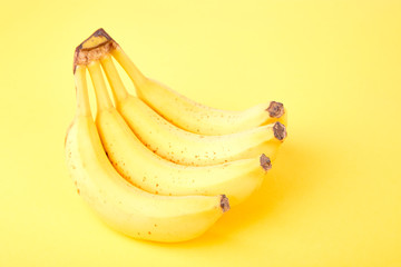 Banana on yellow paper background.
