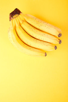 Banana on yellow paper background.