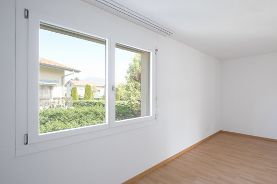 Empty room with parquet and window