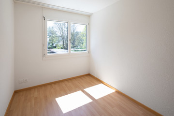 Empty room with parquet and window