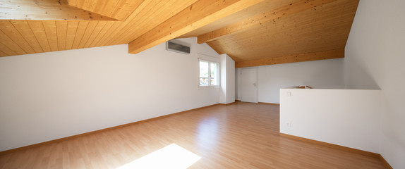 Large attic with wooden floors and exposed beams - obrazy, fototapety, plakaty