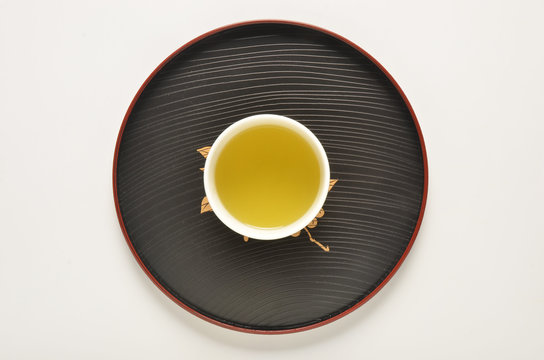 Cup of green tea on a Japanese style tray   