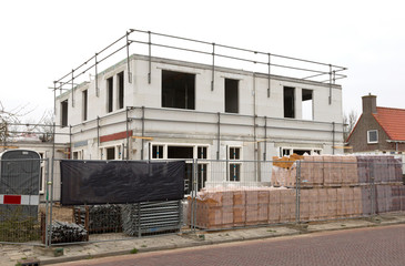Building site with house under construction