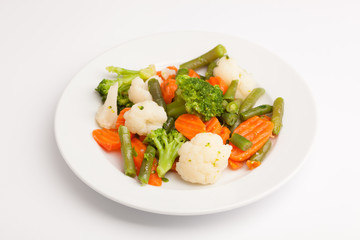 beautiful photo close-up menu of fresh vegetable salad in a plate on a white background