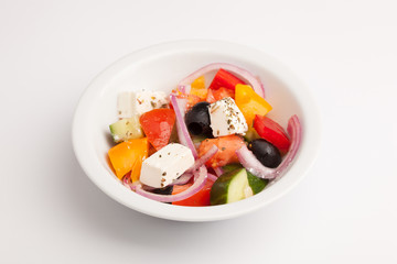 beautiful photo close-up menu of fresh vegetable salad in a plate on a white background