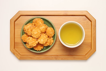 Japanese senbei and green tea on a tray,
