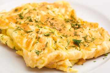 A beautiful photo of a closeup menu of fresh delicious eggs omelet on a plate on a white background