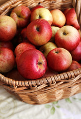 Ripe red and yellow apples close-up in a basket