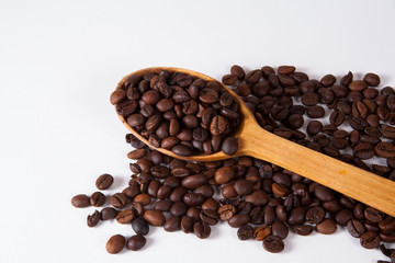 Grain of coffee, beans and spoon. White background