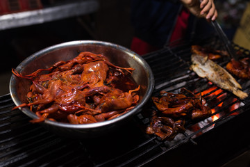 Chicken prepared for grill in Cambodian night street food market 