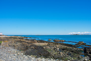 volcanic rock formation on coast of ocean in northern Ireland horizon over water 