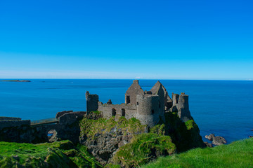 Fototapeta na wymiar beautiful landscape Dunluce Castle against blue sea and sky. one of most popular place in northern ireland 