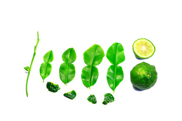 sliced young bergamot fruit and green leaves  with stalk on white background isolated