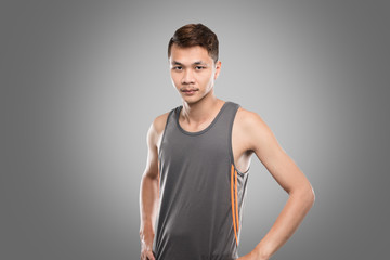 Asian men aged 20-30 years in gray sports suit  on gray background.
