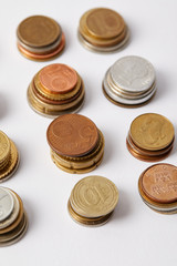 close-up shot of stacks of different coins on white