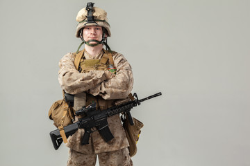 Soldier in camouflage holding rifle