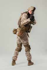 Soldier in camouflage holding rifle