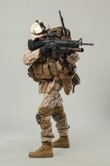 Soldier in camouflage holding rifle