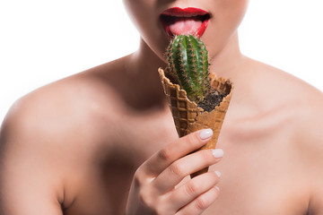 cropped image of woman licking cactus potted in ice cream cone isolated on white © LIGHTFIELD STUDIOS
