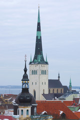 The spire of the church of Oleviste (St. Olaf) close up on a cloudy March day. Tallinn