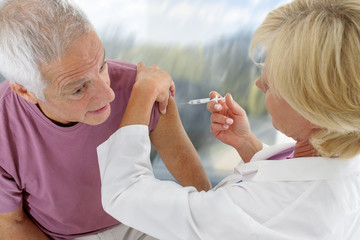 Close up of a patient receiving injection at the hospital