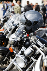 Grey moto helmet on motorcycle handlebars against blurred background