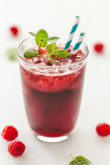 Refreshing drink with raspberry and straw