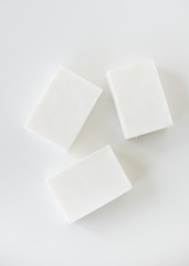 White handmade soap bars on white table