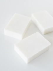 White handmade soap bars on white table
