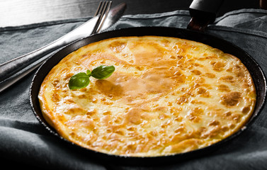eggs omelet in a frying pan on wooden table