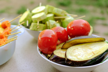 Different raw vegetables, strung on a skewer for grilling. Prepared for a picnic. Concept of healthy, useful food.