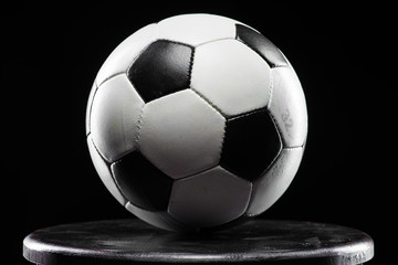 Classic soccer ball on black background, close up