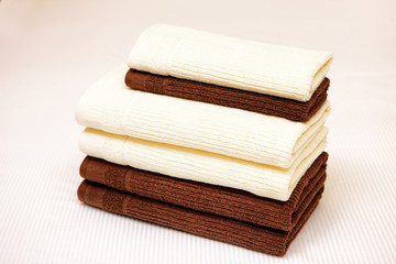 Stack of clean towels on bed