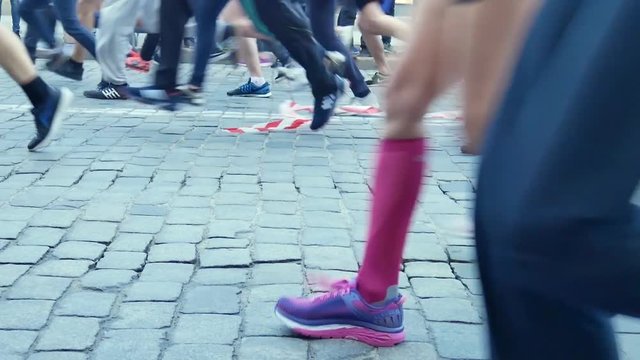 Marathon runners legs on paving stone